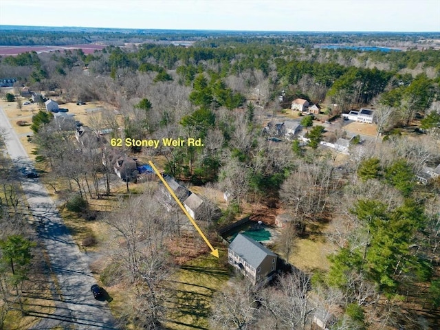 drone / aerial view with a wooded view