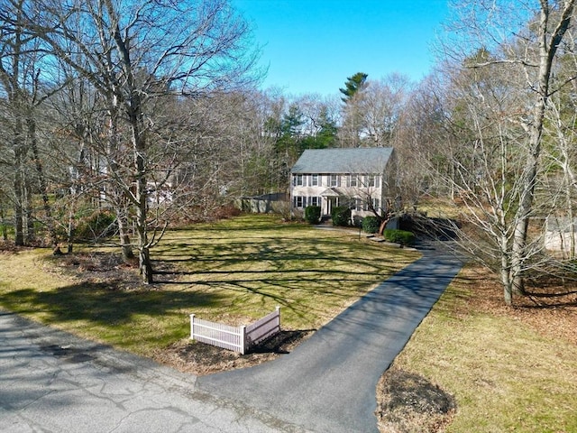 colonial-style house with a front yard