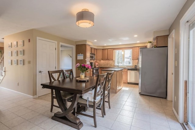 dining room featuring stairs, light tile patterned floors, recessed lighting, and baseboards