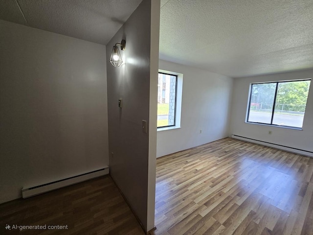 17 Skyline Dr Unit 3, Braintree, MA 02184 - unfurnished room featuring a baseboard radiator, a baseboard heating unit, wood finished floors, and a textured ceiling