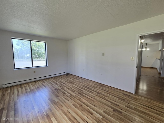 17 Skyline Dr Unit 3, Braintree, MA 02184 - spare room with baseboard heating, wood finished floors, and a textured ceiling