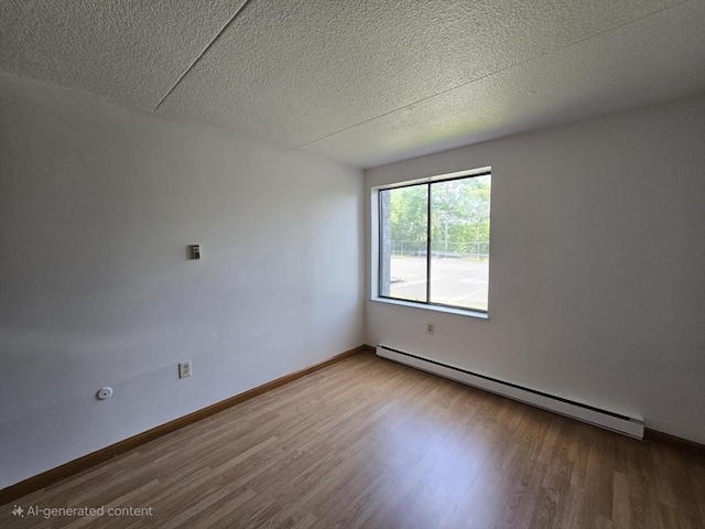 17 Skyline Dr Unit 3, Braintree, MA 02184 - empty room with a baseboard heating unit, wood finished floors, and a textured ceiling