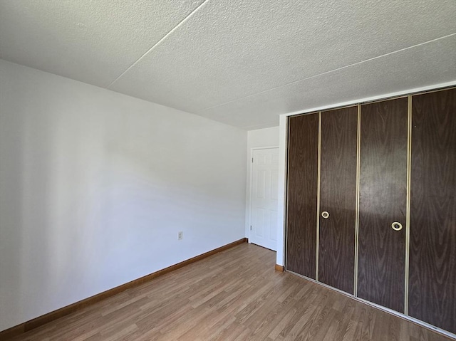17 Skyline Dr Unit 3, Braintree, MA 02184 - unfurnished bedroom featuring wood finished floors, a closet, and a textured ceiling
