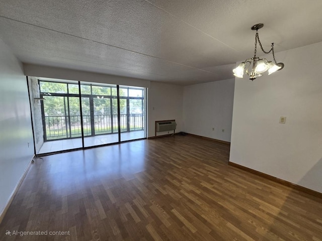 17 Skyline Dr Unit 3, Braintree, MA 02184 - unfurnished living room featuring wood finished floors, a wall unit AC, a textured ceiling, and a chandelier