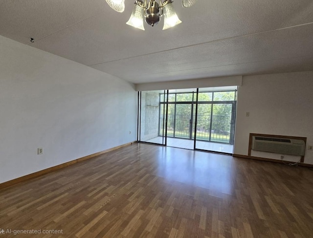 17 Skyline Dr Unit 3, Braintree, MA 02184 - spare room featuring wood finished floors, an AC wall unit, a chandelier, and a textured ceiling