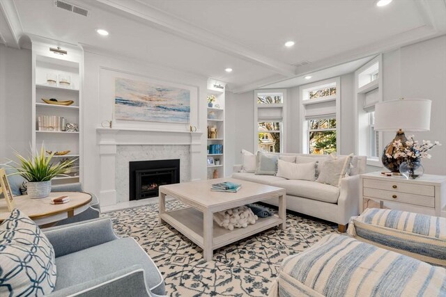 living area with visible vents, built in shelves, beamed ceiling, a fireplace with flush hearth, and recessed lighting