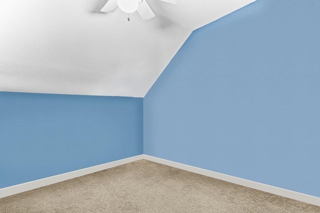 bonus room featuring ceiling fan, carpet, baseboards, and vaulted ceiling