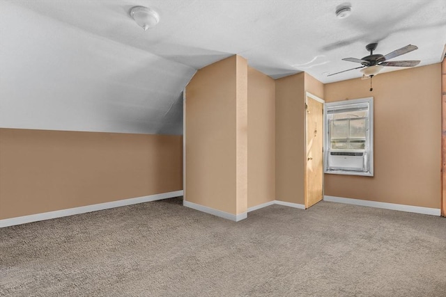 additional living space with vaulted ceiling, carpet floors, ceiling fan, and baseboards