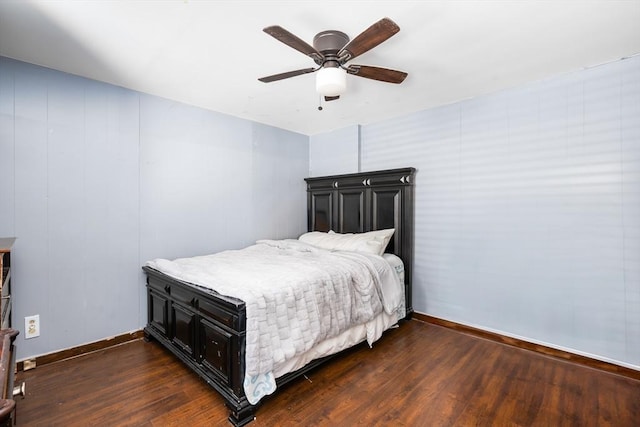 bedroom featuring ceiling fan, dark wood finished floors, and baseboards