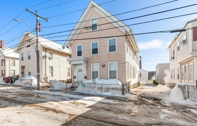 view of front of home featuring fence