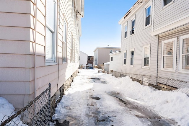 view of snow covered exterior with fence