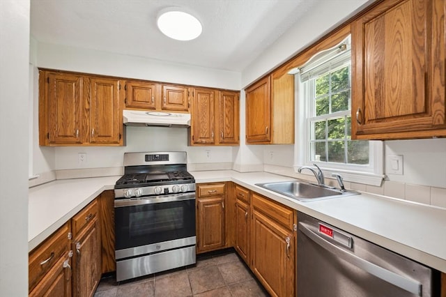523 Washington St Unit A9, Pembroke, MA 02359 - kitchen featuring stainless steel appliances, under cabinet range hood, and brown cabinets