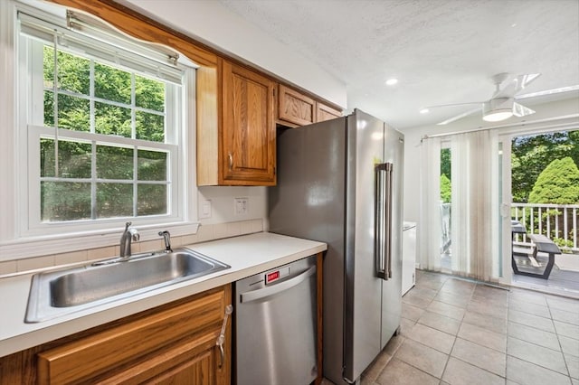 523 Washington St Unit A9, Pembroke, MA 02359 - kitchen featuring appliances with stainless steel finishes, brown cabinetry, a ceiling fan, light tile patterned floors, and light countertops