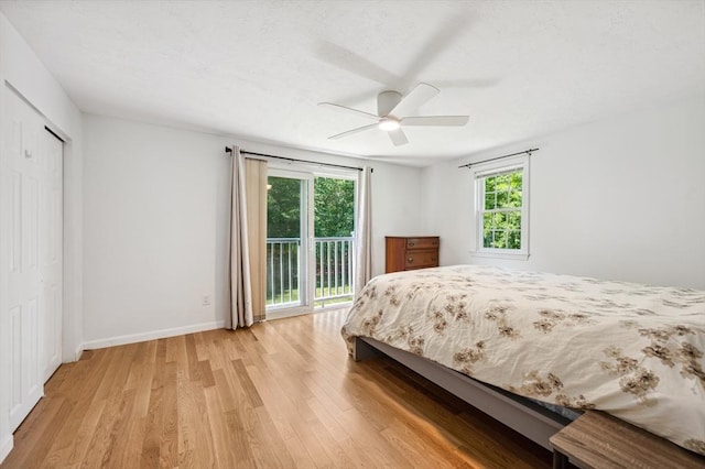523 Washington St Unit A9, Pembroke, MA 02359 - bedroom featuring light wood-type flooring, a closet, access to exterior, and a ceiling fan