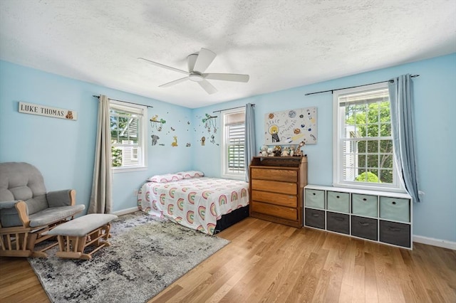 523 Washington St Unit A9, Pembroke, MA 02359 - bedroom featuring multiple windows, light wood-style floors, and a textured ceiling