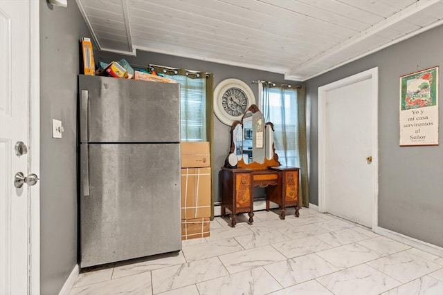 interior space featuring baseboards, freestanding refrigerator, and marble finish floor