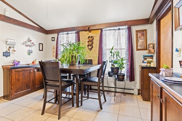 dining room featuring baseboard heating, light tile patterned flooring, and lofted ceiling