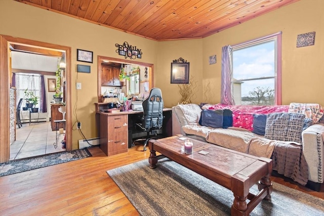living area with light wood-style floors, a baseboard heating unit, and ornamental molding