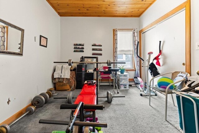 workout area with a baseboard radiator, wooden ceiling, and baseboards