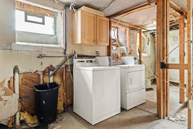 washroom with cabinet space and washer and dryer