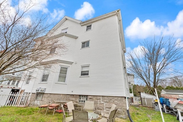back of property with a yard and fence