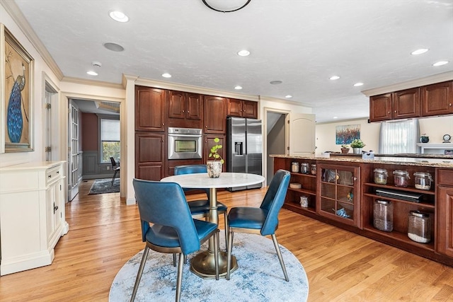 dining room featuring recessed lighting, ornamental molding, and light wood-style flooring