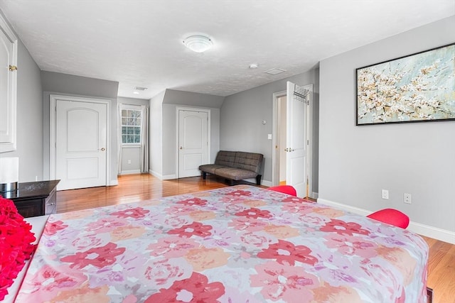 bedroom with wood finished floors and baseboards