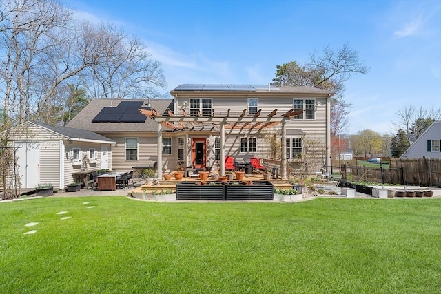 rear view of house with an outdoor living space, a garden, a patio, solar panels, and a pergola