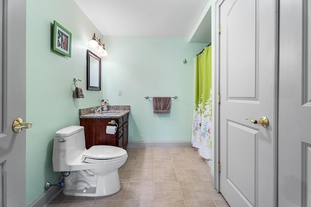 bathroom with toilet, tile patterned flooring, vanity, and baseboards
