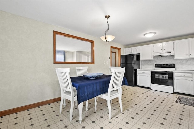 kitchen with freestanding refrigerator, under cabinet range hood, white cabinetry, and range with electric cooktop