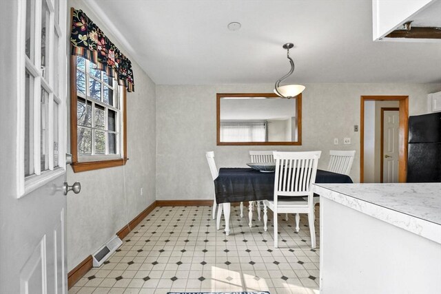 dining space with baseboards and visible vents