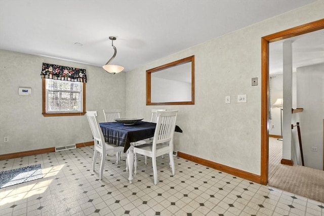 dining space featuring baseboards, visible vents, and tile patterned floors