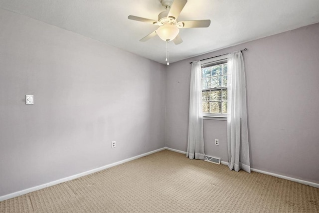 spare room with light carpet, baseboards, and visible vents