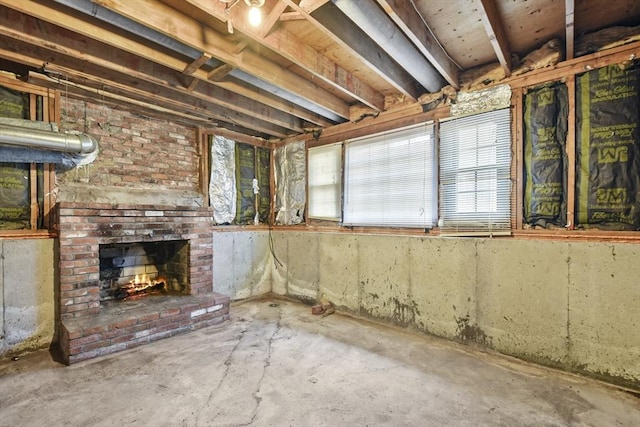 basement featuring a brick fireplace