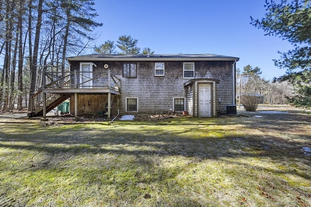 view of front facade with stairs, a front lawn, central AC, and a wooden deck