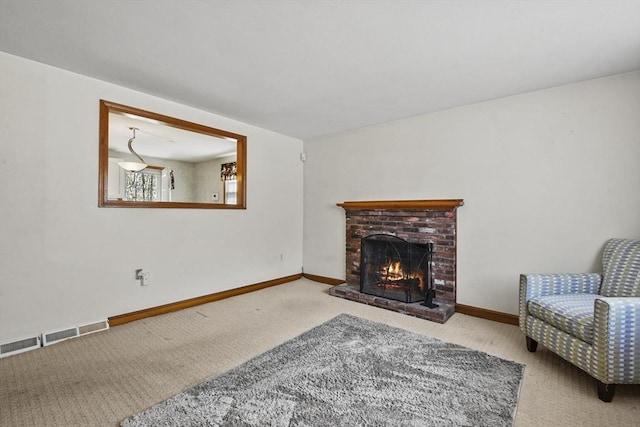 living room with carpet floors, a fireplace, visible vents, and baseboards