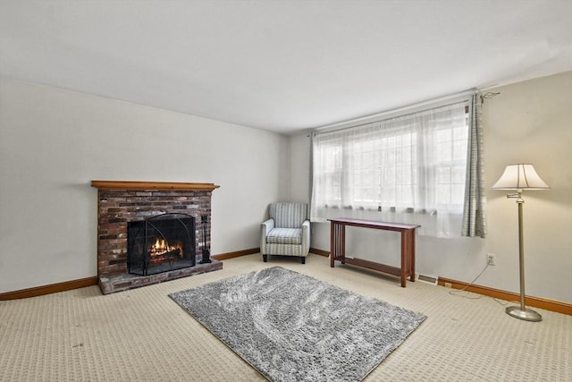 sitting room with carpet floors, a fireplace, and baseboards