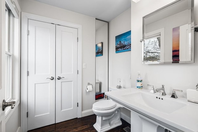 131 Dorchester St Unit 131, Quincy, MA 02171 - bathroom featuring a sink, toilet, wood finished floors, and baseboards