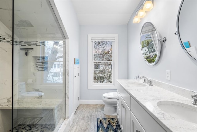 131 Dorchester St Unit 131, Quincy, MA 02171 - bathroom featuring tiled shower, toilet, baseboards, and double vanity