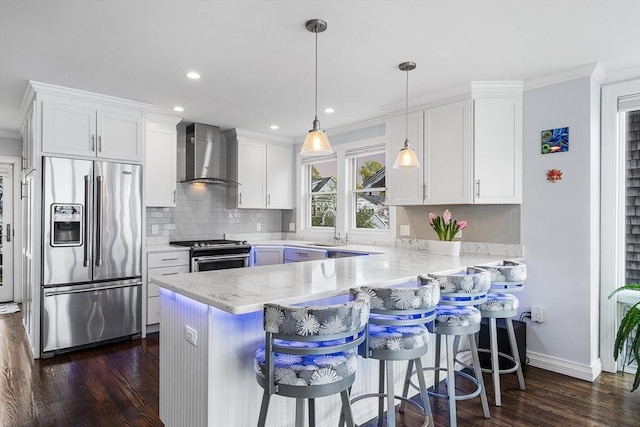 131 Dorchester St Unit 131, Quincy, MA 02171 - kitchen with stainless steel appliances, wall chimney range hood, dark wood finished floors, white cabinetry, and a peninsula