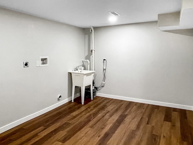 washroom featuring dark wood-type flooring, washer hookup, and hookup for an electric dryer