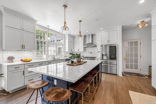 1 Webster Ln, Wilbraham, MA 01095 - kitchen with stainless steel fridge with ice dispenser, wall chimney exhaust hood, a sink, tasteful backsplash, and recessed lighting