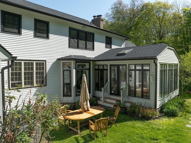 1 Webster Ln, Wilbraham, MA 01095 - back of house with a sunroom, a chimney, roof with shingles, a lawn, and entry steps