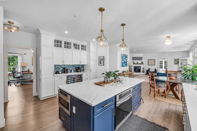 1 Webster Ln, Wilbraham, MA 01095 - kitchen with blue cabinetry, white cabinetry, wood finished floors, a desk, and recessed lighting