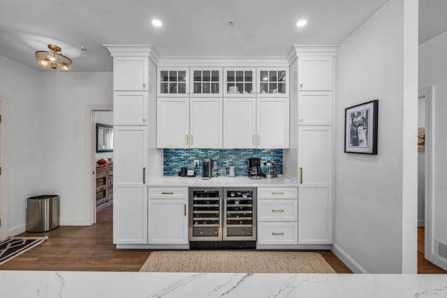 1 Webster Ln, Wilbraham, MA 01095 - indoor dry bar featuring beverage cooler, dark wood finished floors, backsplash, baseboards, and recessed lighting