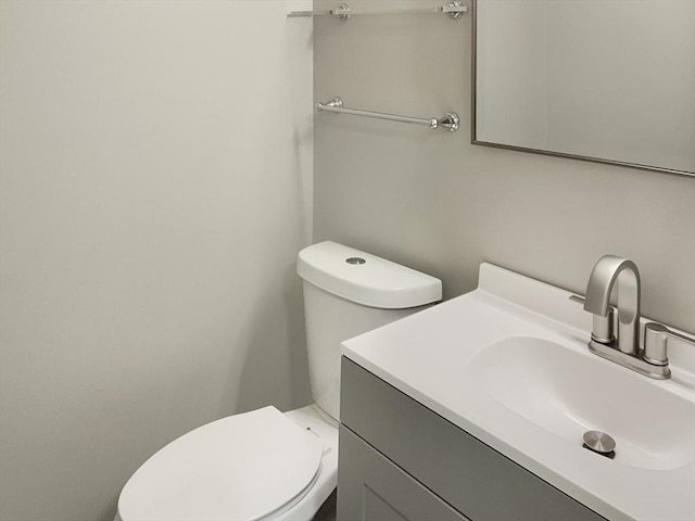 bathroom featuring toilet and vanity