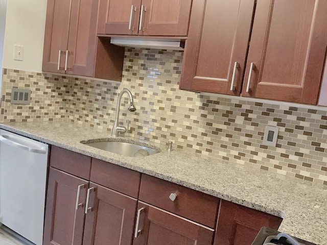 kitchen with a sink, tasteful backsplash, light stone counters, and dishwasher