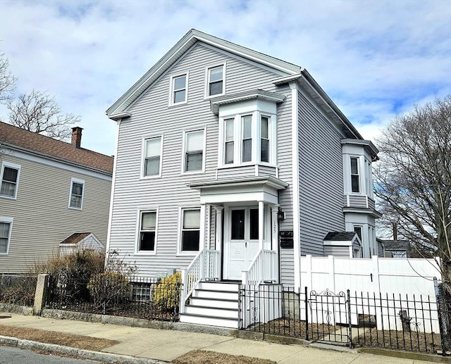 view of front of property featuring fence