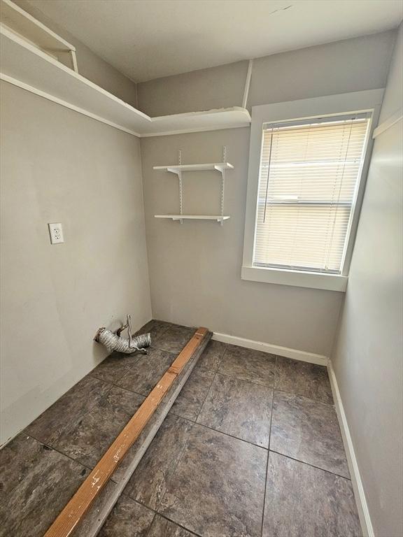 laundry room featuring baseboards