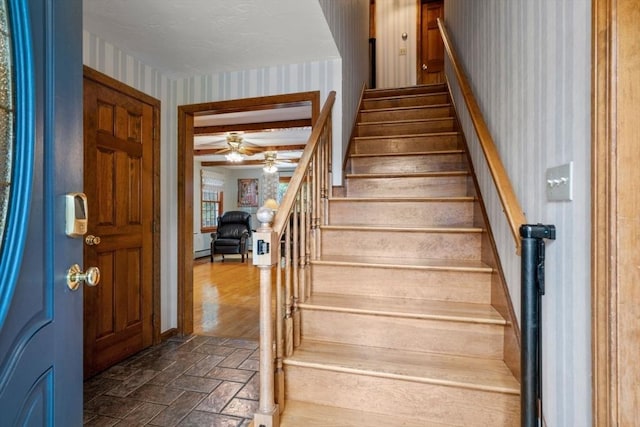 23 Lafayette Dr, Walpole, MA 02032 - stairway with wallpapered walls, brick patterned flooring, and a ceiling fan